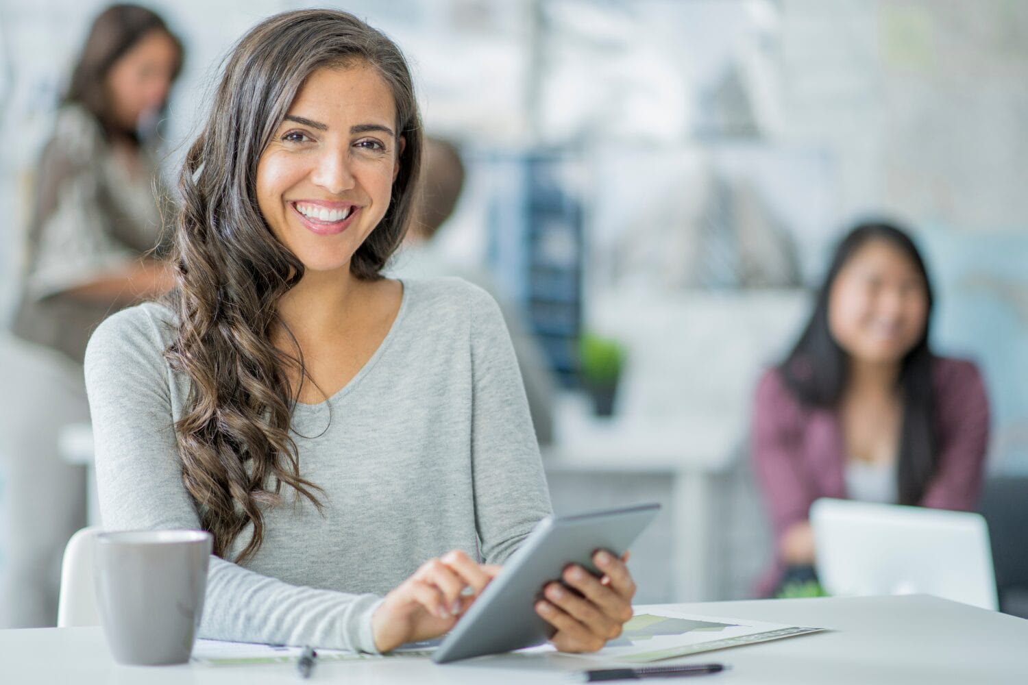 Smiling woman using a tablet