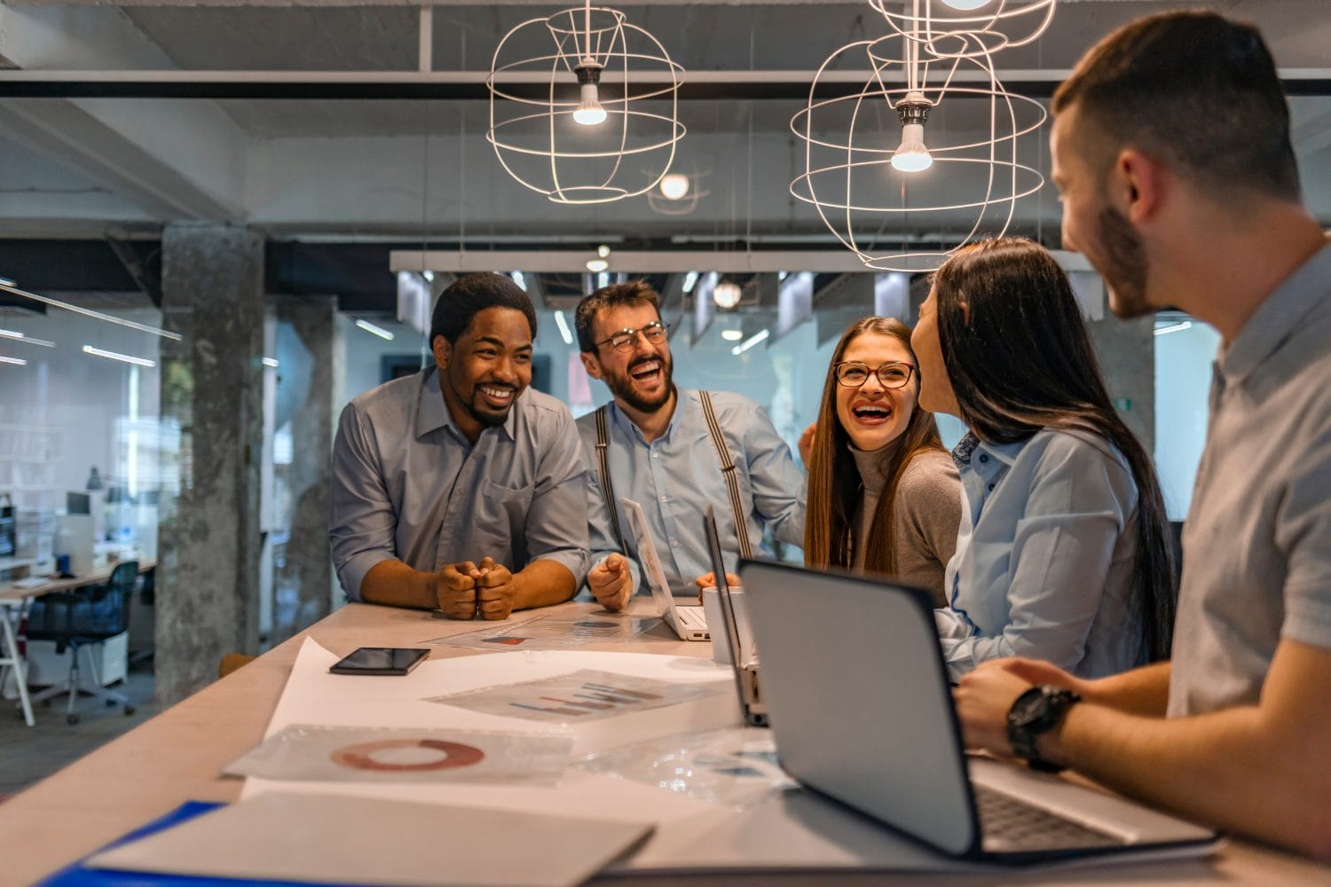 Happy people talking at a boardroom table